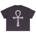 A dark charcoal gray short-sleeve crop top t-shirt featuring a large white graphic of an Ankh symbol composed of cannabis leaves, displayed flat against a solid white background.