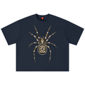 A navy blue short-sleeve t-shirt featuring a large spider graphic on the chest, constructed from gold and white rhinestones, set against a plain white background.