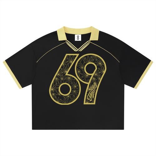 A black short-sleeve retro-style jersey with a gold collar and sleeve trim, featuring a large gold number 69 with floral line art and the word 'Surrey' on the front.