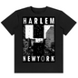 A black short-sleeve crewneck t-shirt featuring a bold black and white graphic print on the front with the words 'HARLEM NEWYORK' framing a stylized city street scene.