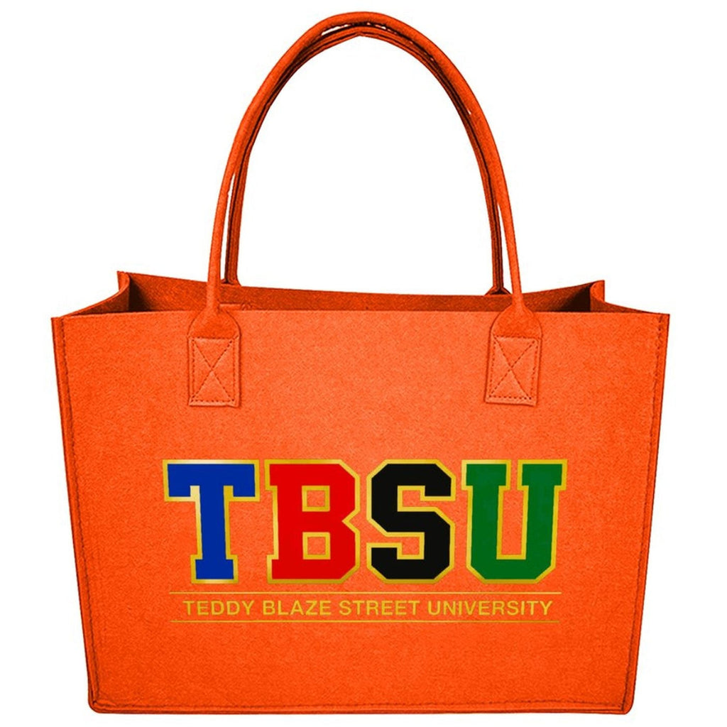 An orange felt tote bag with double shoulder straps, featuring the letters 'TBSU' in blue, red, black, and green, with 'TEDDY BLAZE STREET UNIVERSITY' printed below in yellow, on a white background.