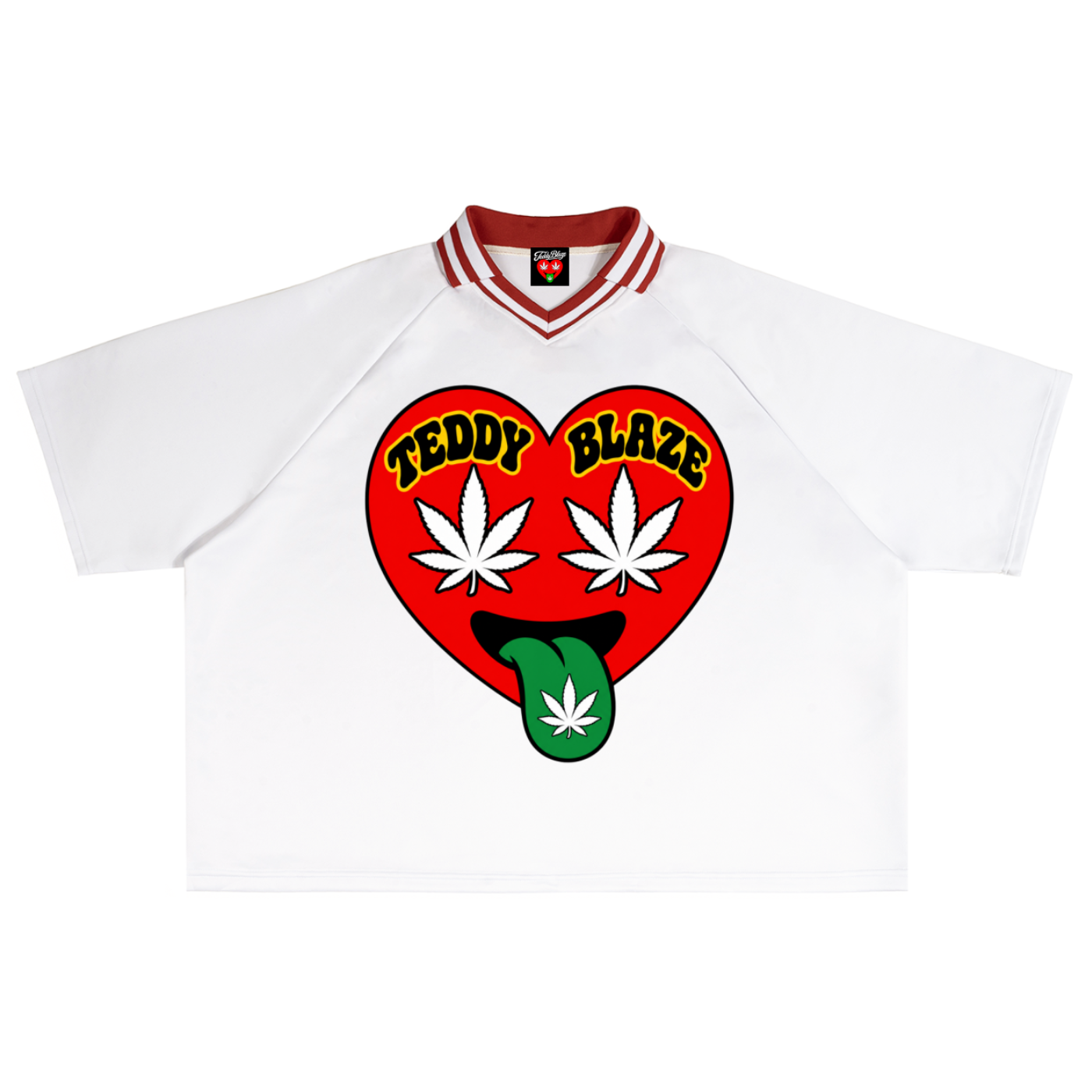 A white short-sleeve T-shirt with a red and white striped collar, featuring a large red heart graphic on the chest with the words 'TEDDY BLAZE' in yellow, white cannabis leaves, and a green tongue sticking out with a cannabis leaf.