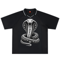 A black short-sleeve polo shirt featuring a large white and gray graphic of a cobra snake coiled in the center, with a white collar trim and a small red logo on the inner neck label.