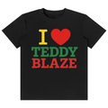 A black short-sleeve crewneck t-shirt featuring a graphic print that reads 'I [red heart] TEDDY BLAZE' in yellow, green, and red block letters, displayed on a solid white background.
