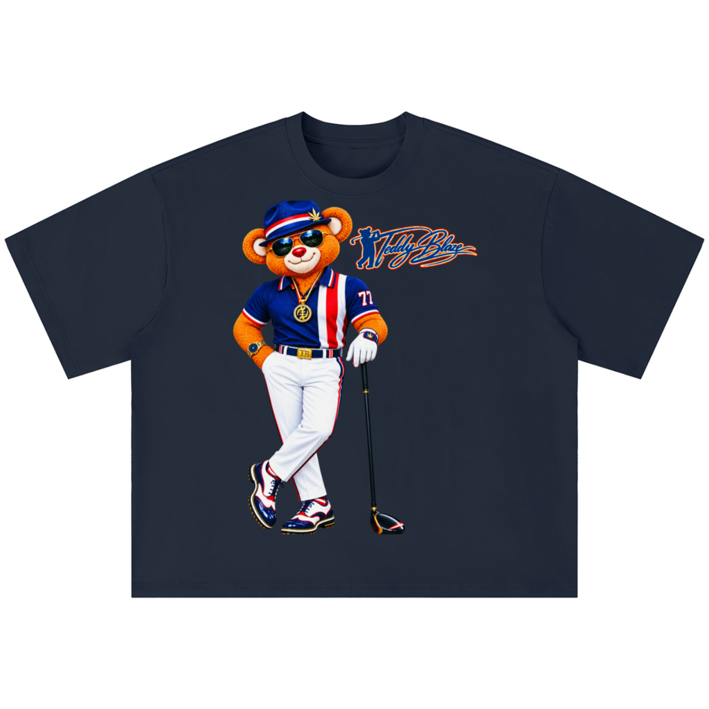 A dark navy blue short-sleeve t-shirt with a graphic of a cartoon bear wearing a baseball uniform and sunglasses, holding a golf club, with a stylized 'The Fly' logo printed on the chest.