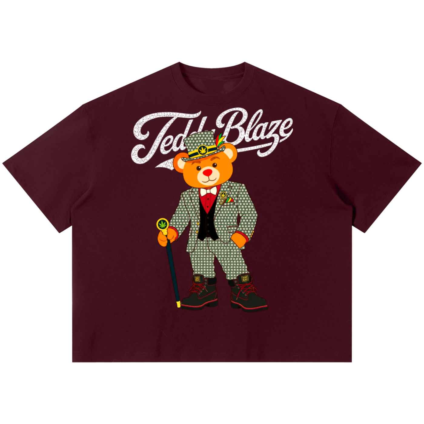 A maroon short-sleeve t-shirt featuring a graphic of a teddy bear in a green checkered suit and hat with the text 'Teddl Blaze' in white script across the chest, displayed on a solid white background.