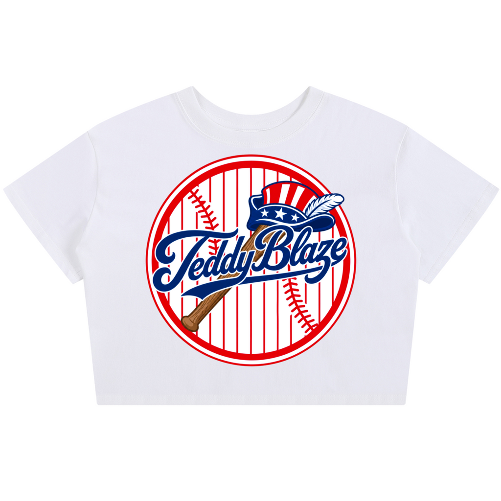 A white short-sleeve crop top t-shirt featuring a circular 'Teddy Blaze' baseball graphic on the front, displayed against a solid white background.