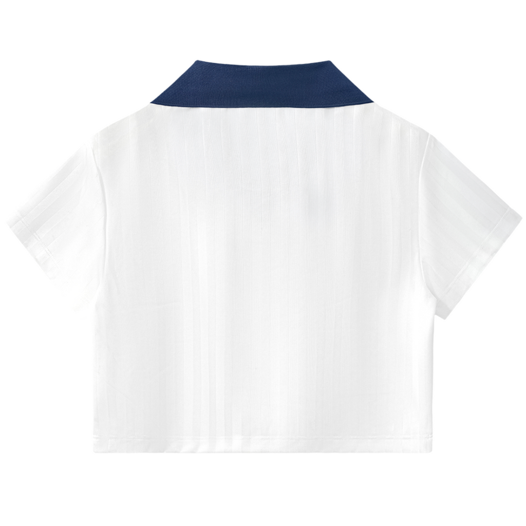 White polo shirt with navy collar on a white background