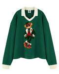 Shop the Iron + Ivy Signature Santa Blaze Contrast Trim Long Polo by Teddy Blaze. Heavyweight 320 GSM forest green cotton-poly long-sleeve polo with cream contrast collar and festive Santa bear graphic.