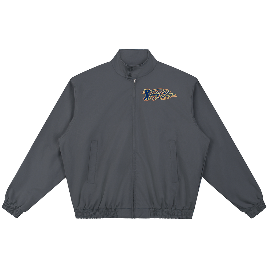 A dark gray zip-up jacket with a stand collar, elastic cuffs, and side pockets, featuring a stylized embroidered logo on the left chest in gold and navy blue, displayed on a solid white background.