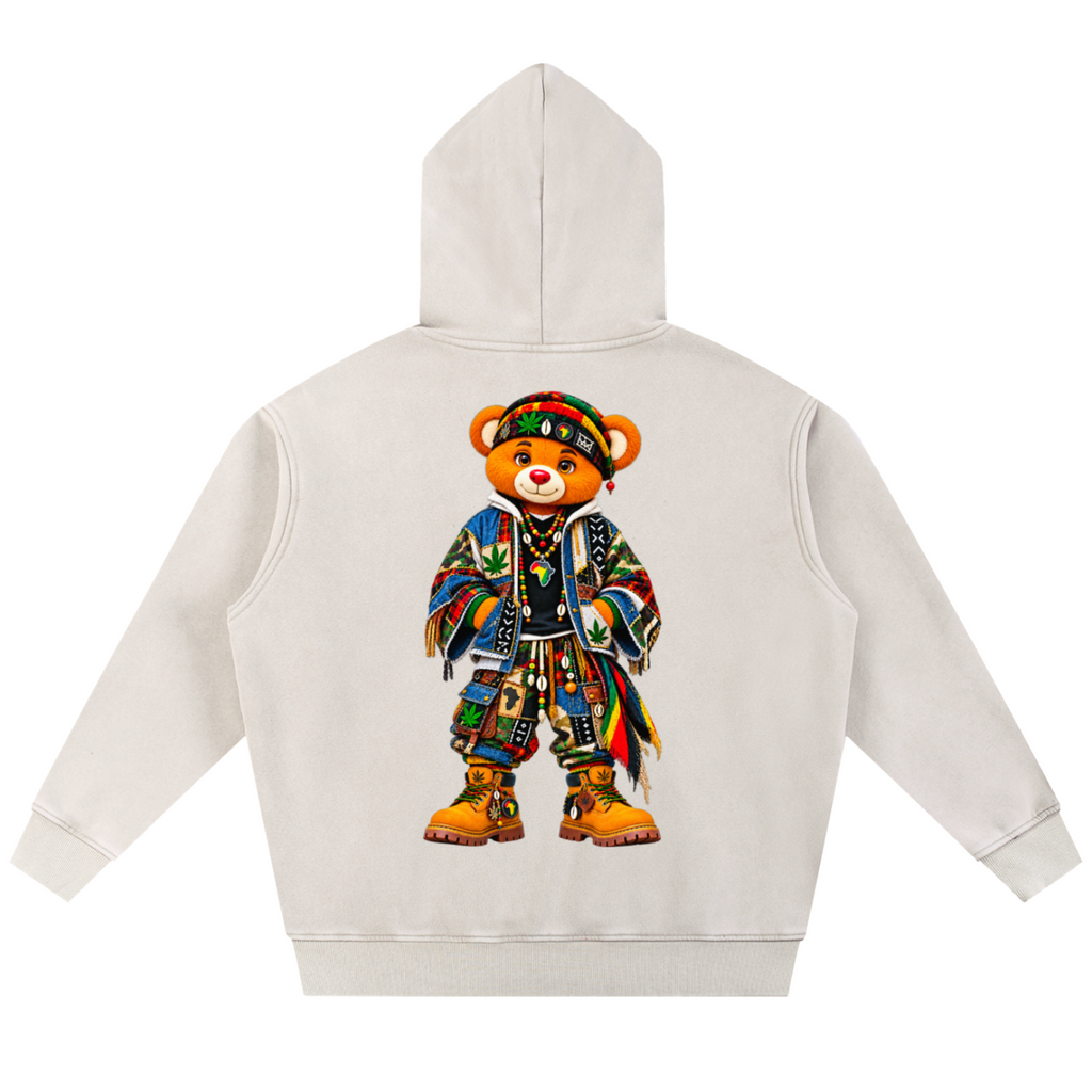 A cream-colored hoodie shown from the back, featuring a large graphic of a teddy bear wearing a colorful, patterned outfit and a green patterned hat.