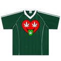 A dark green short-sleeve soccer-style jersey with a white V-neck collar, white shoulder stripes, and a large chest graphic of a red heart with white cannabis leaves and a green tongue.