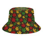 A bucket hat featuring an all-over repeating pattern of cannabis leaves in red, green, and yellow on a black background, shown against a plain white studio backdrop.