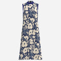 Teddy Blaze Adire floral A-line dress featuring an indigo and cream textile design, high neckline, ankle length silhouette, and Black Ivy elegance.