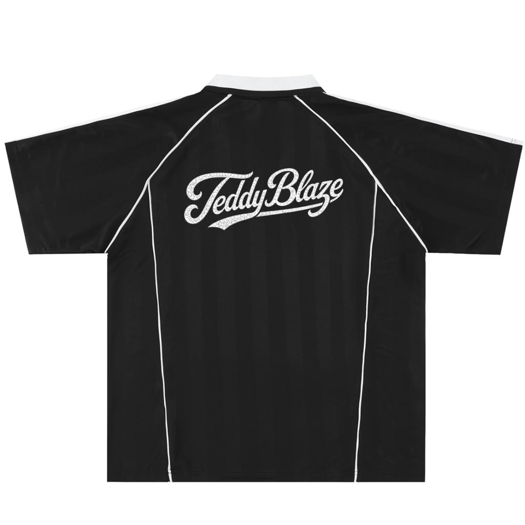 A black short-sleeve athletic jersey with white contrast stitching, a white collar, and a white 'Teddy Blaze' script logo printed across the upper back, shown on a plain white background.