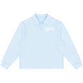 A light blue long-sleeve polo shirt with a white cursive 'Fools Day' graphic on the left chest, displayed flat against a solid white background.