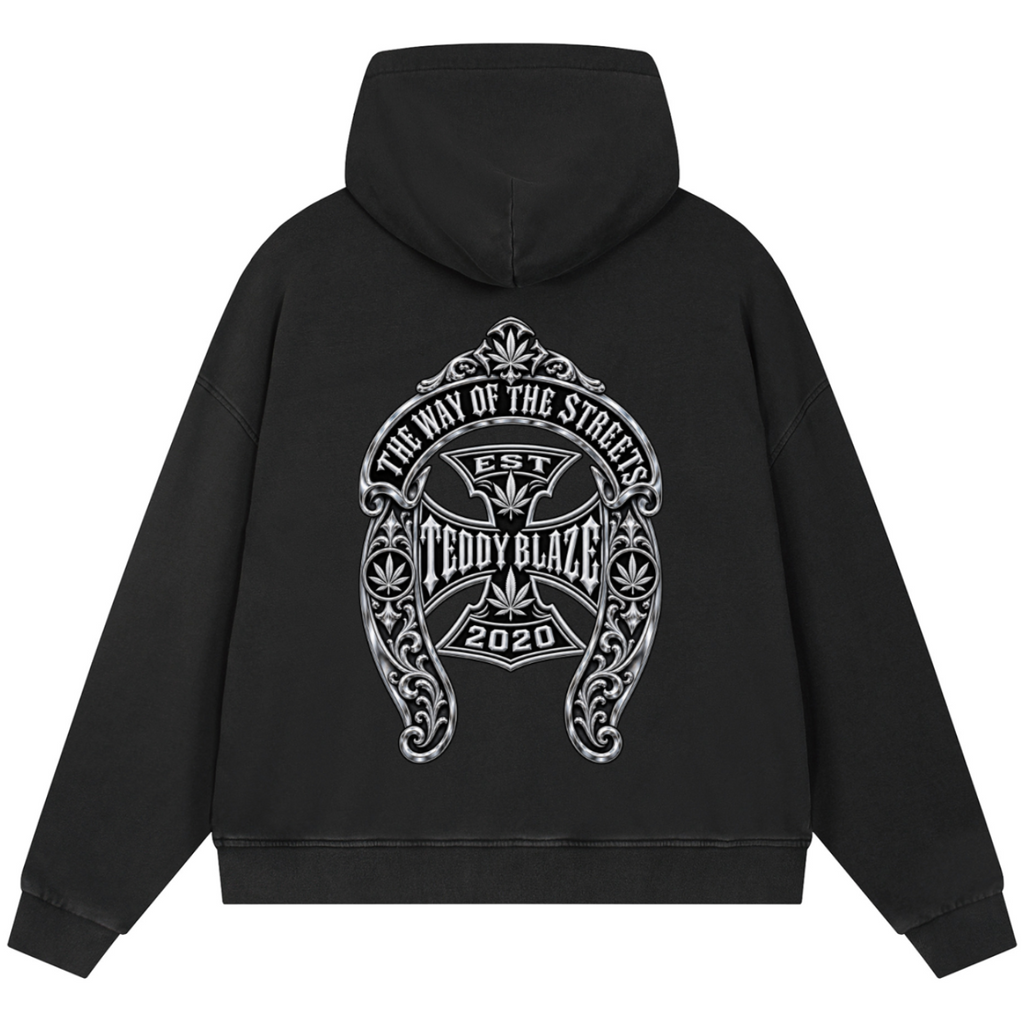 A black pullover hoodie shown from the back, featuring a large white graphic print with the text 'The Way of the Stigmas', 'Teddy Blaze', and '2020' on a plain white background.