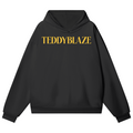 Elevate your cold-weather layers with the House of Teddy Blaze Beardusa Hidden Pocket Fleece Hoodie. Black 460 gsm fleece, hidden side pockets, gold block lettering, and gold Medusa bear graphic. Shop NYC to Vegas style.