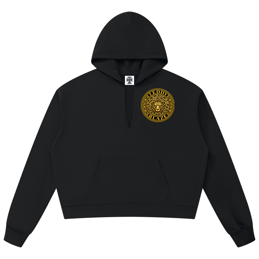Elevate your statement outerwear with the House of Teddy Blaze Beardusa V-Neck Box Cut Raw Edge Fleece Hoodie. Black 360 gsm fleece, notched V-neck collar, raw edge details, and gold Medusa bear graphics. Shop NYC to Vegas style.