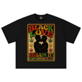 A black short-sleeve t-shirt with a large, colorful graphic print on the front. The graphic features the words 'BLACK LOVE RECLAIM IT!' in a retro red, yellow, and green font, flanking a silhouette of two people embracing, with cannabis leaves in the background.