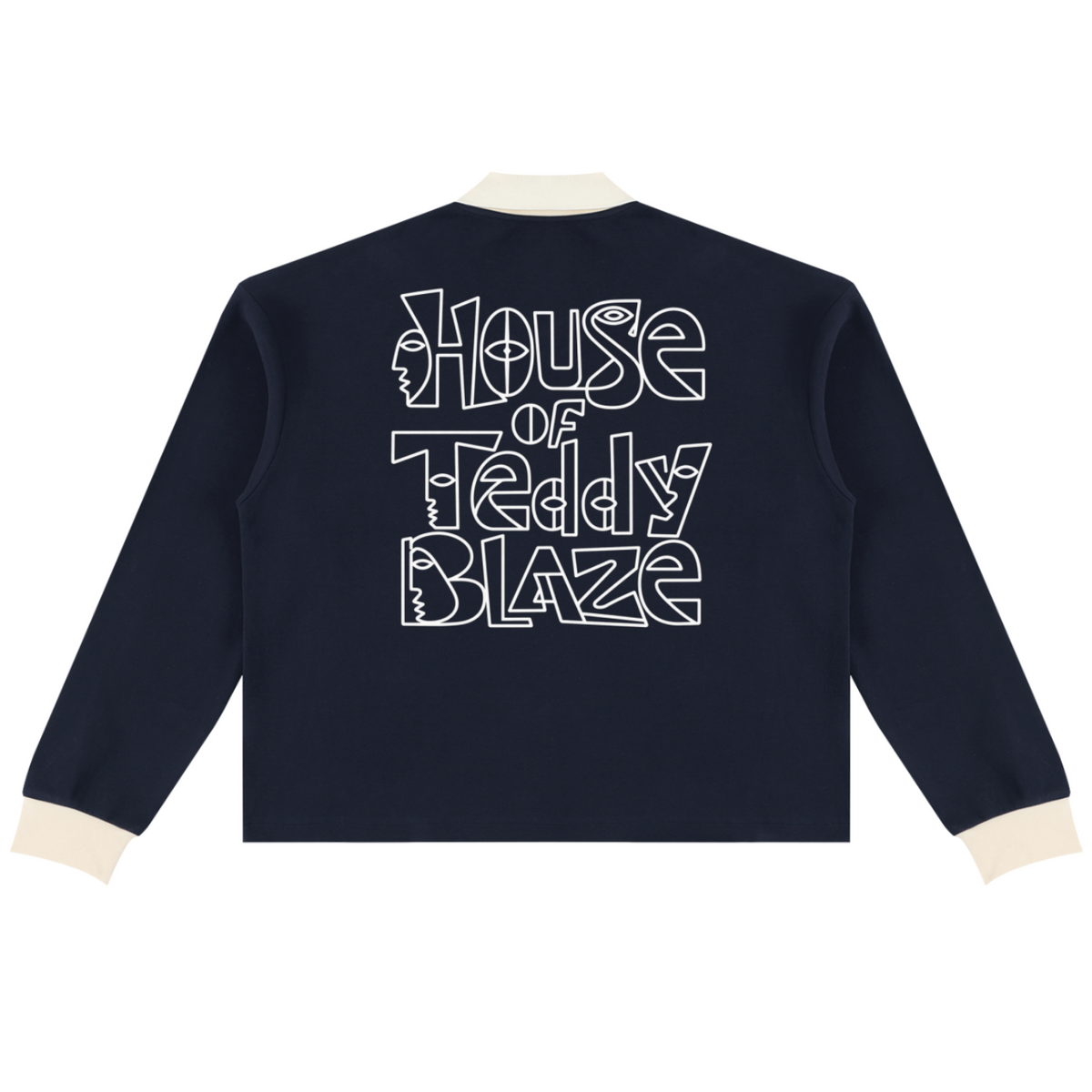 A navy blue long-sleeve cropped jacket shown from the back, featuring a large white graphic text print that reads 'House of Teddy Blaze' with teddy bear silhouettes inside the letters. The jacket has contrasting cream-colored ribbed collar, cuffs, and hem, and is displayed on a clean white background.