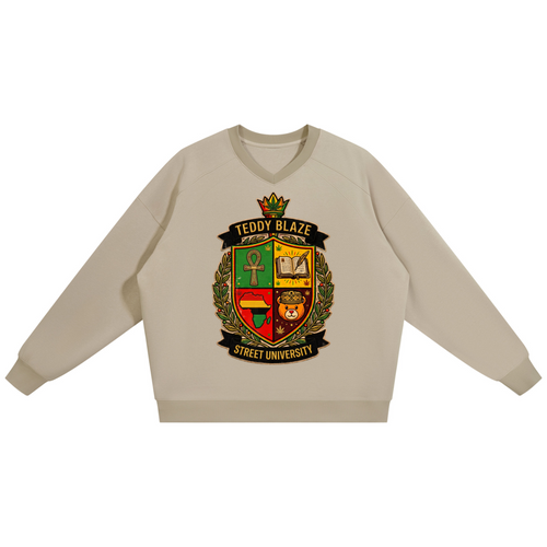 A light beige crewneck sweatshirt featuring a large, detailed 'Teddy Blaze Street University' crest graphic printed on the chest, displayed against a solid white background.