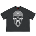 A black short-sleeve t-shirt featuring a large white skull graphic on the front, decorated with a dotted pattern and a cannabis leaf on the forehead. The shirt is displayed flat against a solid white background.