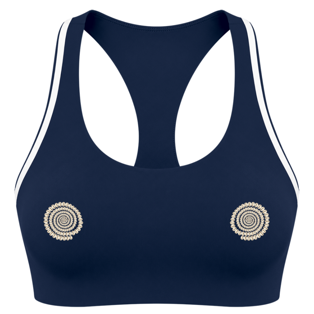 A navy blue sports bra with white double stripes along the shoulders and white underwire cups, featuring two circular gold-toned spiral designs on the cups, shown against a plain white background.