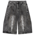 Heavyweight vintage-wash denim jorts from Teddy Blaze featuring a relaxed long silhouette, Afrodemia iconography and signature DaCruz detailing