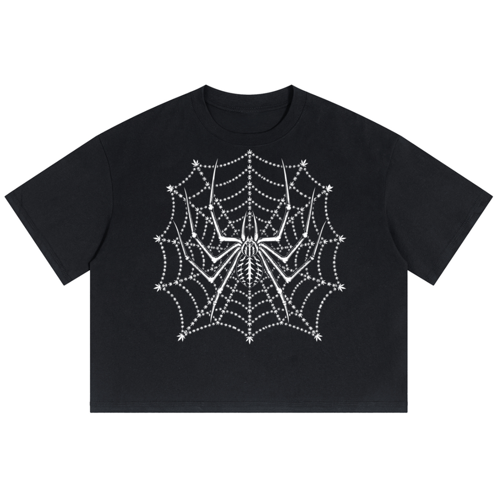 A black short-sleeve crop top t-shirt featuring a white spiderweb and spider graphic printed on the front, displayed against a solid white background.