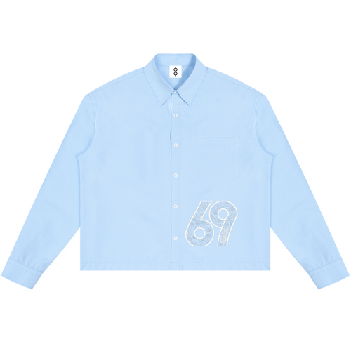 A light blue long-sleeve button-up shirt with a white distressed graphic of the number '69' on the lower right front, displayed flat against a solid white background.