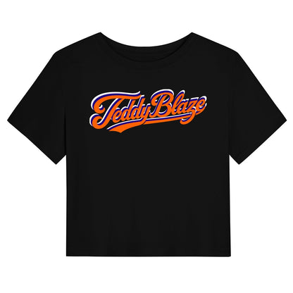A black short-sleeve crop top t-shirt featuring a stylized 'Teddy Blaze' logo printed across the chest in orange and white script.