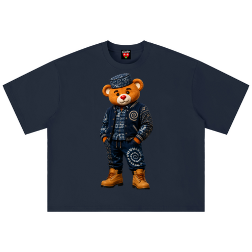 A navy blue short-sleeve t-shirt featuring a graphic of a teddy bear wearing a detailed blue and white patterned outfit with brown boots, displayed flat against a white background.