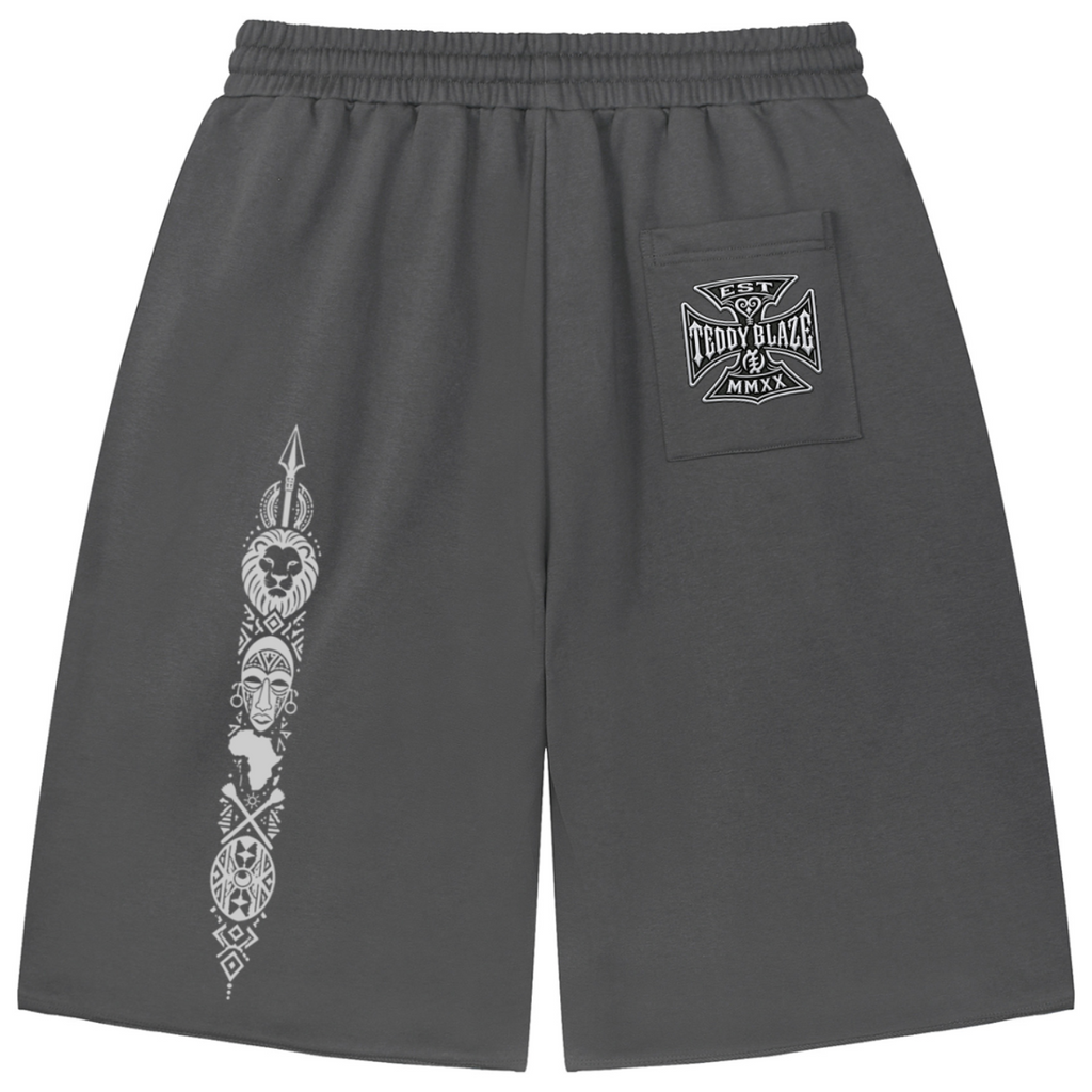Heavyweight loose-fit charcoal shorts featuring Teddy Blaze Afrodemia Americana artwork, DaCruz detailing, drawstring waist and raw-edge streetwear styling.
