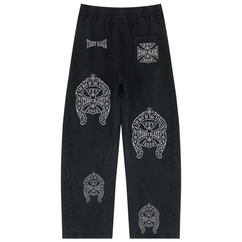 Black sweatpants with multiple white graphic prints and logos, including 'Crazy Dog' and skull designs, shown flat against a white background.
