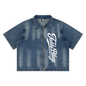 A unisex zip-up denim camp shirt with a bold Signature front graphic, washed denim finish, and BK Collection streetwear energy.