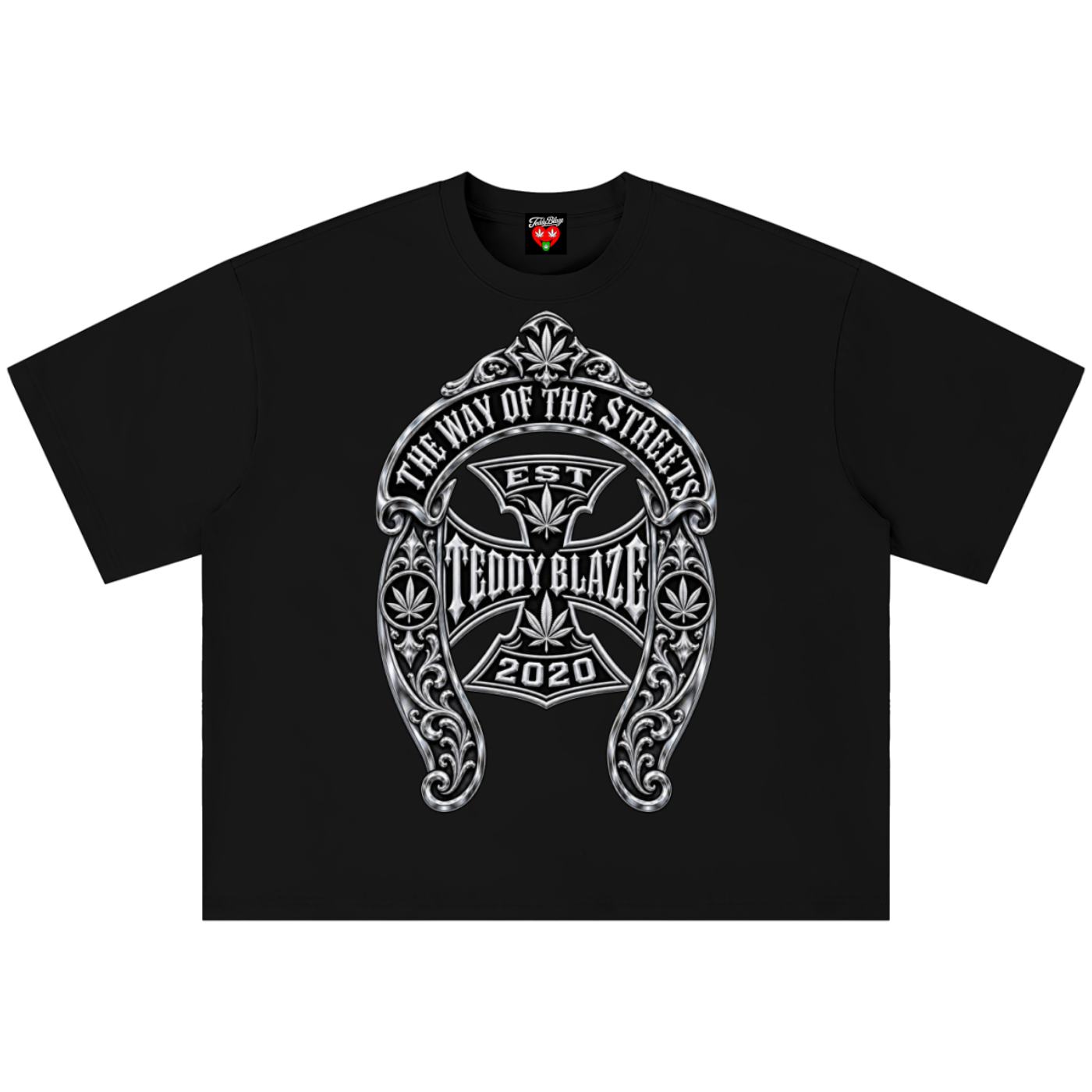 A black short-sleeve crewneck t-shirt featuring a large white and gray graphic print on the front. The graphic is an ornate crest with an iron cross and the text 'THE WAY OF THE SINNER', 'EST TEDDY BLAZE', and '2020'.