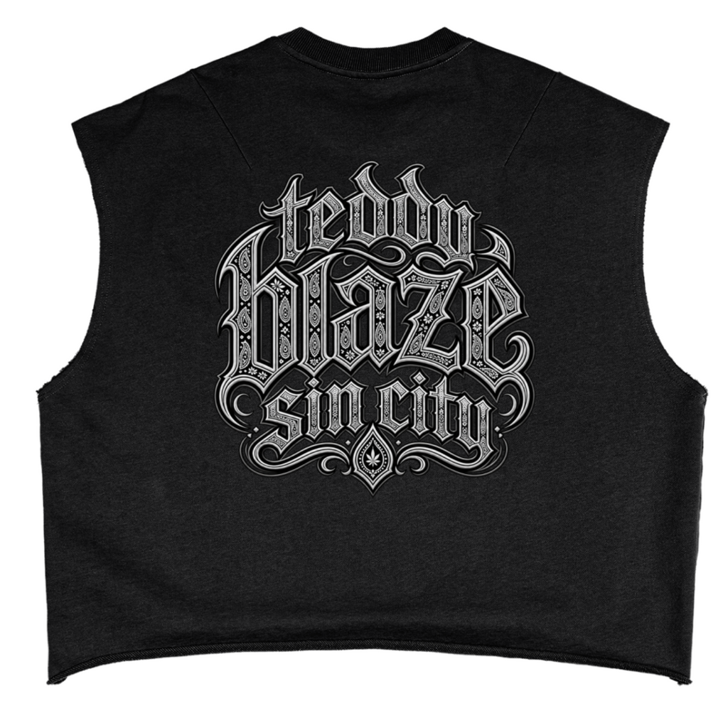 Elevate your sleeveless style with the Teddy Blaze Sin City Sacred French Terry Box Cut Tank. Black heavy French terry, frayed armholes, and tattoo praying hands print. Shop NYC to Vegas style.