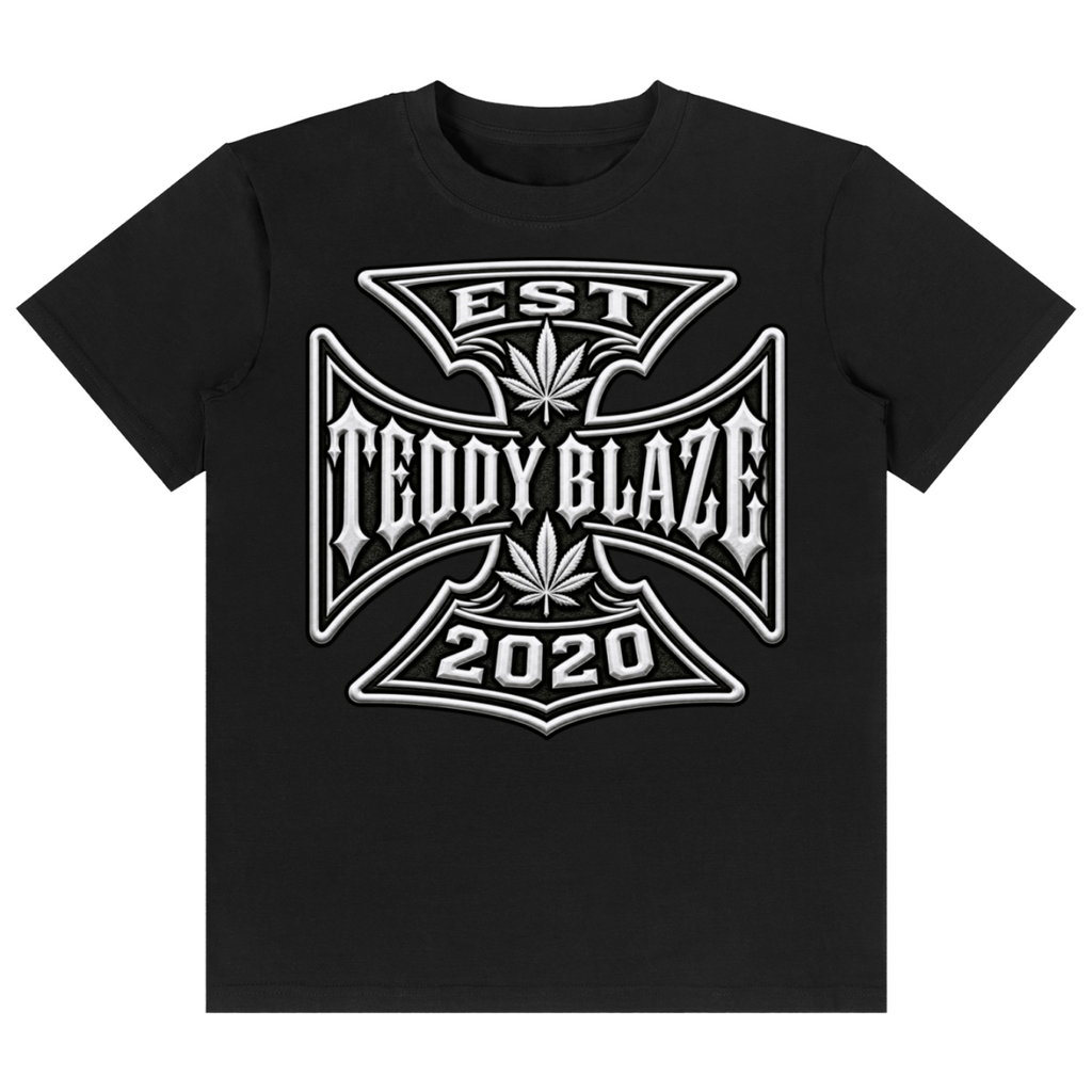 Shop the DaCruz Classic Tee by Teddy Blaze. 180 GSM cotton-spandex stretch tee featuring a silver gothic cross graphic from the TOPS line of The Mature Mocha Collection.