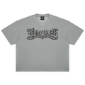 A heather gray short-sleeve t-shirt with a stylized black and white gothic-style 'TEDDY BLAZE' graphic printed across the chest, displayed flat against a solid white background.