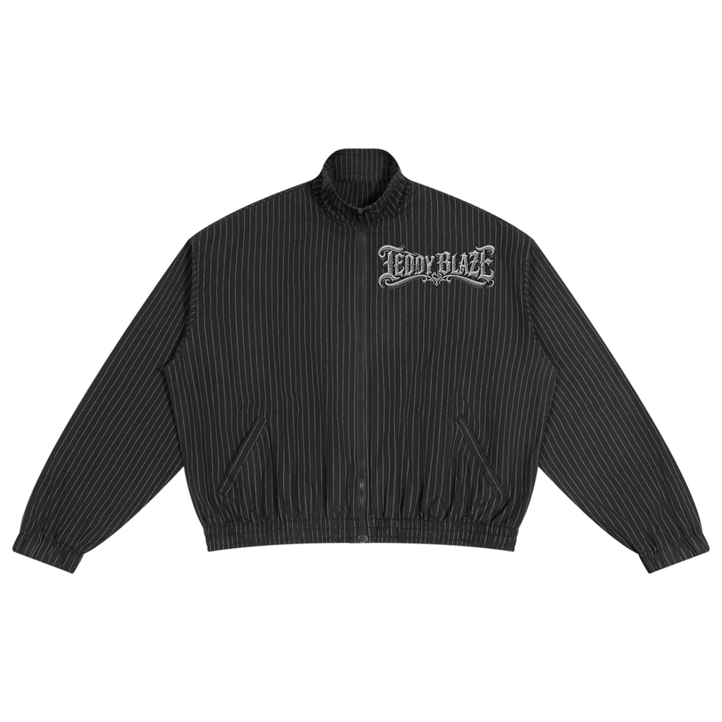Black pinstriped track jacket with a Teddy Blaze Signature chest graphic and bold DaCruz crest at back. A sharp unisex streetwear layer.