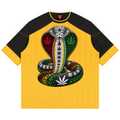 A yellow and black raglan t-shirt featuring a large graphic of a Rastafarian cobra snake with cannabis leaves on its scales, set against a plain white background.
