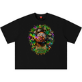 A black short-sleeve crewneck t-shirt featuring a vibrant, colorful graphic print on the front. The graphic depicts a stylized portrait of a person with a blindfold, surrounded by green marijuana leaves, gold coins, and stacks of dollar bills, with the text 'FUCK THE SYSTEM' written below.