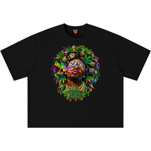 A black short-sleeve crewneck t-shirt featuring a vibrant, colorful graphic print on the front. The graphic depicts a stylized portrait of a person with a blindfold, surrounded by green marijuana leaves, gold coins, and stacks of dollar bills, with the text 'FUCK THE SYSTEM' written below.