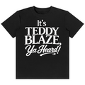 A black short-sleeve crewneck t-shirt with the phrase 'It's TEDDY BLAZE, Ya Heard!' printed in bold white text on the front, displayed against a solid white background.