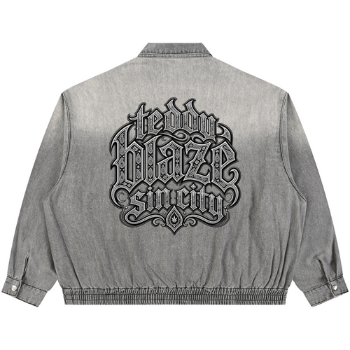 Elevate your transitional outerwear with the Teddy Blaze Sin City Vintage Wash Denim Jacket. Sun-washed gray denim, zip front, elastic hem, and filigree house back graphic. Shop NYC to Vegas style.