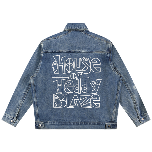 A blue denim jacket shown from the back, featuring a large white graphic text print that reads 'House of Teddy Blaze' across the back.