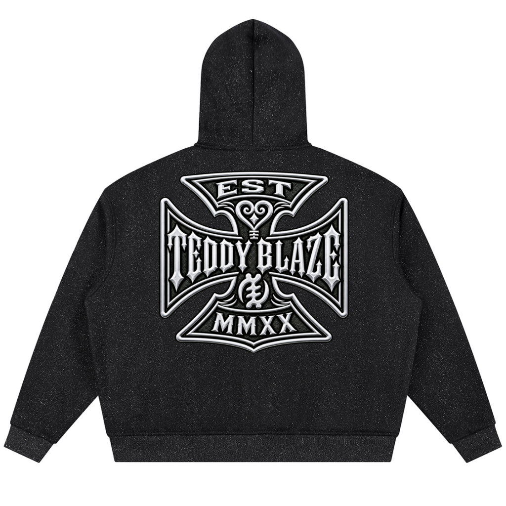 A black heathered hoodie shown from the back, featuring a large white graphic print with the text 'EST TEDDY BLAZE MMXX' inside a decorative cross-like emblem.