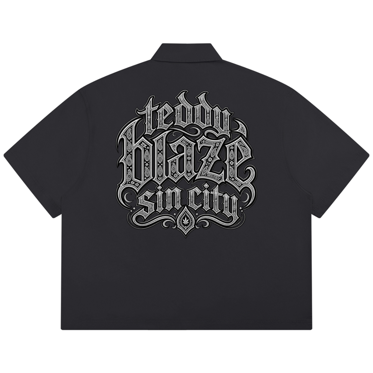 Elevate your resort wardrobe with the Teddy Blaze Sin City Sacred Box Cut Cotton Camp Shirt. Charcoal cotton button-down, lapel collar, and tattoo praying hands print. Shop NYC to Vegas style.