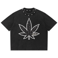 A black short-sleeve crop top t-shirt with a white outlined cannabis leaf graphic on the front, featuring a small 'Fate' brand logo integrated into the leaf design. The shirt has silver metal studs along the collar.